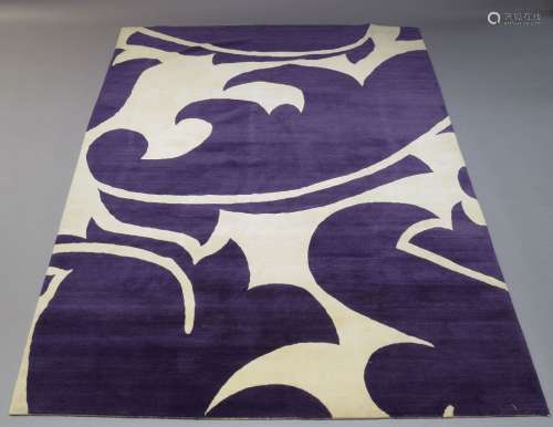 A modern wool carpet, late 20th Century, with asymmetric white design on purple ground, 270cm x