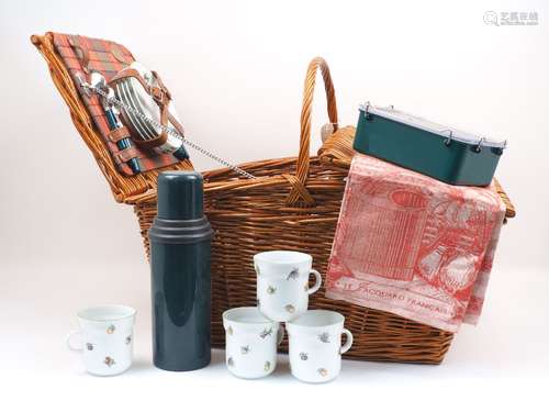 A Fortnum and Mason picnic basket, with settings for four, to include plates, cups and saucers,