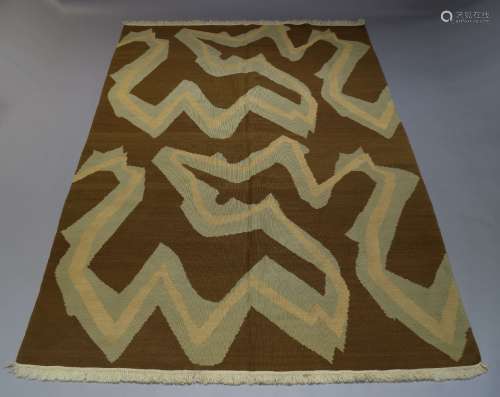 A Scandinavian flat weave rug, mid 20th Century, with white and blue design in brown field, 303cm