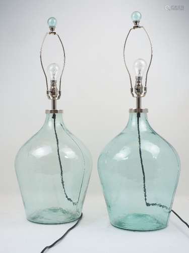 A pair of modern table lamps, each designed with clear blue glass bodies, of tapering form, with