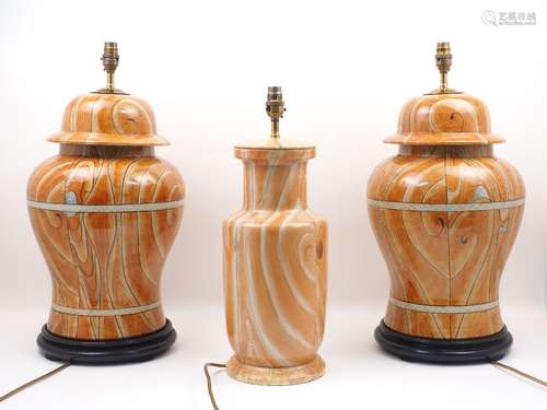 A pair of table lamps, each of baluster form, with faux wood grain colouration, electrical