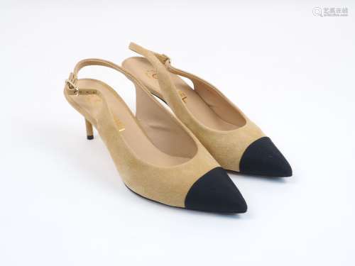 A pair of Chanel sling-back heeled pumps, designed in beige and black, with adjustable buckle