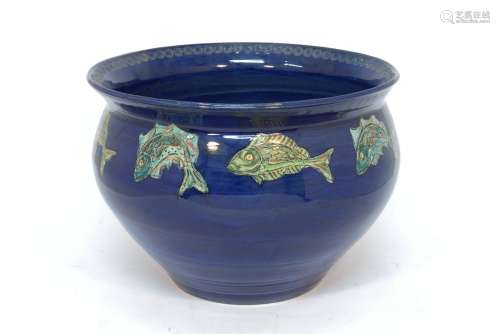 A large early 20th century blue glazed jardiniere of bulbous form with flared rim, decorated to