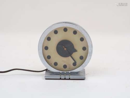A Gilbert Rohde (1894-1944) style clock, the cream face decorated with minimal circular '