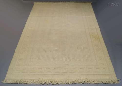 A Scandinavian wool cream ground carpet, with raised field and Greek key border, 336cm x 238cmPlease