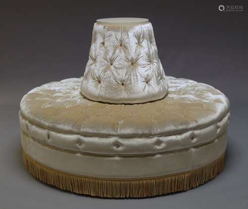 A circular conversation sofa, late 20th Century, with buttoned fawn velvet upholstery, with tassel