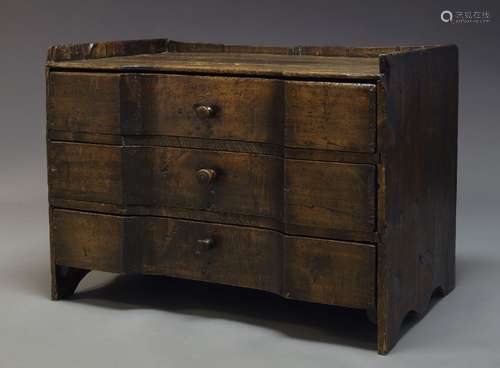 A Continental provincial stained pine chest, 18th Century and later, of inverse breakfront form,