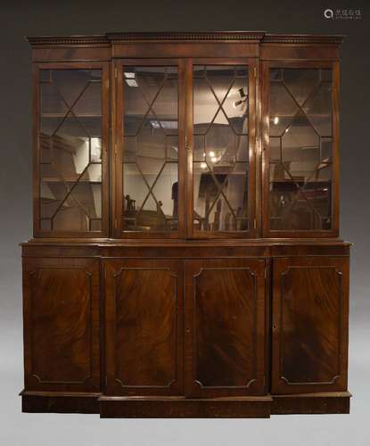 A George III style mahogany breakfront bookcase, late 20th Century, the dentil moulded cornice above