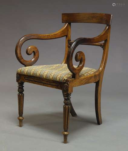 A Regency rosewood bar back armchair, with curved scrolling arms, above needlework upholstered