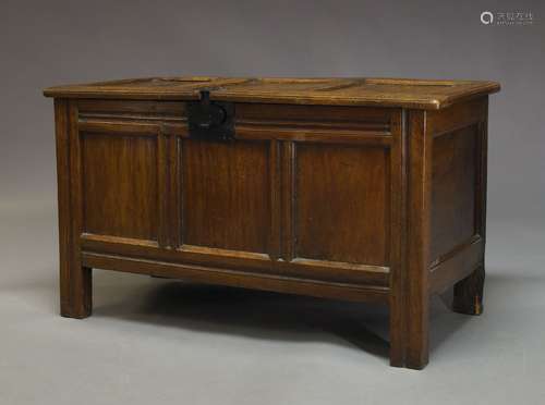 An oak coffer, 18th Century and later, the hinged lid enclosing storage space and candle box, with