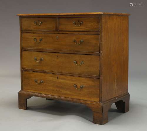 A George III mahogany chest with two short over three long graduated drawers, raised on bracket