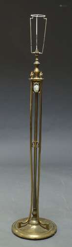 A brass standard lamp, late 19th, early 20th Century, with vase and flame finial top, inset with