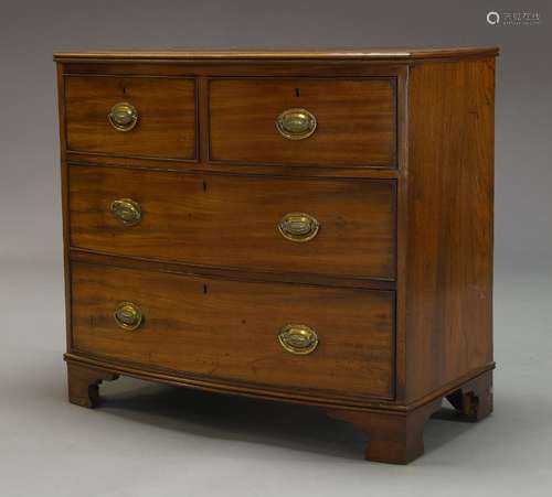 A Regency mahogany bow front chest, with two short over two long graduated drawers, raised on shaped