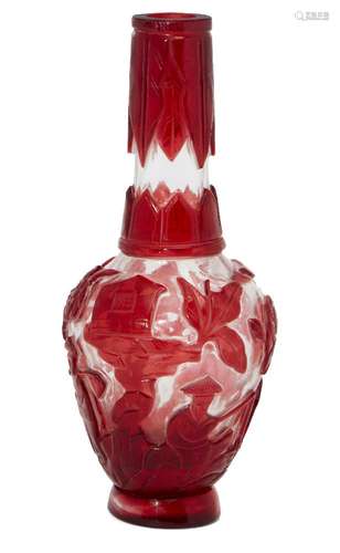 A Chinese Peking red-overlay glass bottle vase, early 20th century, carved with figures in a village