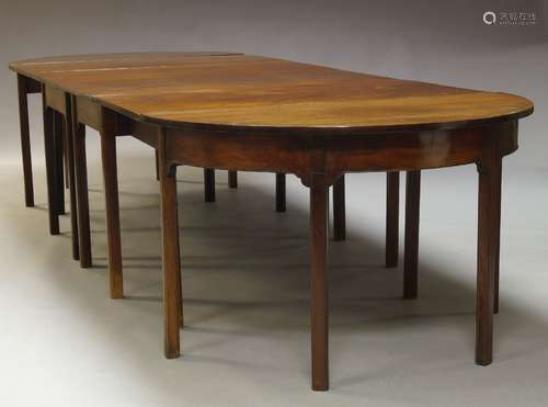 A George III and later mahogany D-end dining table, the rounded rectangular top with two later D-