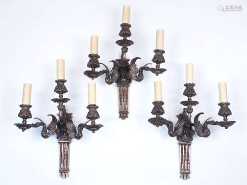 A group of three 19th century copper three branch wall lights, each with two lights raised on