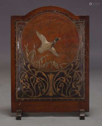 An Edwardian mahogany fire screen, with embossed leather panel depicting a duck in flight with Art