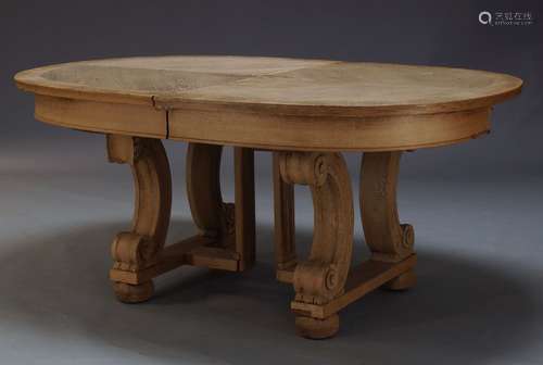 An oak extending dining table, second half 20th Century, the rounded rectangular top with two