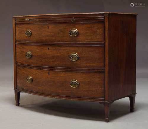 A Regency mahogany bow fronted chest of drawers, with brushing slide over three long graduated