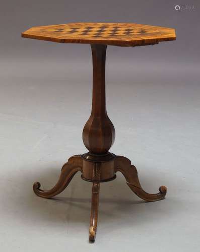 A Victorian walnut games table, the octagonal top inlaid with chessboard, on baluster form