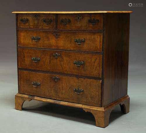 A George II and later walnut and crossbanded chest, with two short over three long drawers, raised