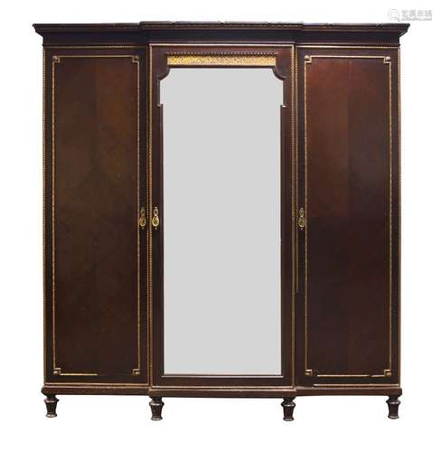 A mahogany and parcel gilt breakfront triple wardrobe, early 20th Century, the moulded cornice above