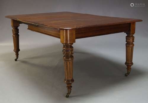 A Victorian mahogany extending dining table, the rounded rectangular top, with two additional leaves