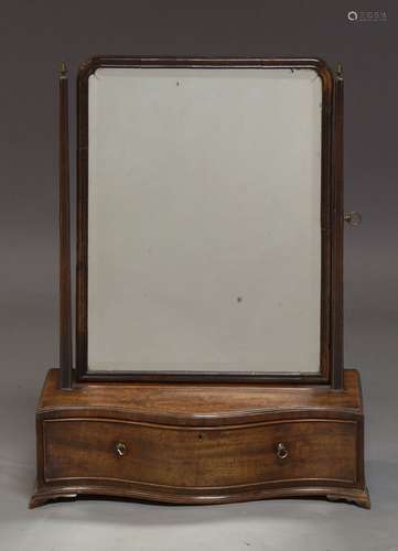 A George III mahogany swing frame dressing table mirror, of arched form, with square finialed