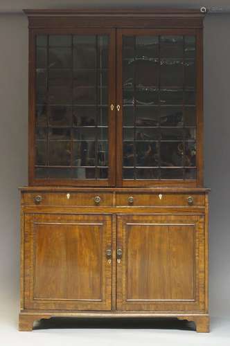 A George III mahogany bookcase, the moulded cornice above two astragal glazed doors enclosing