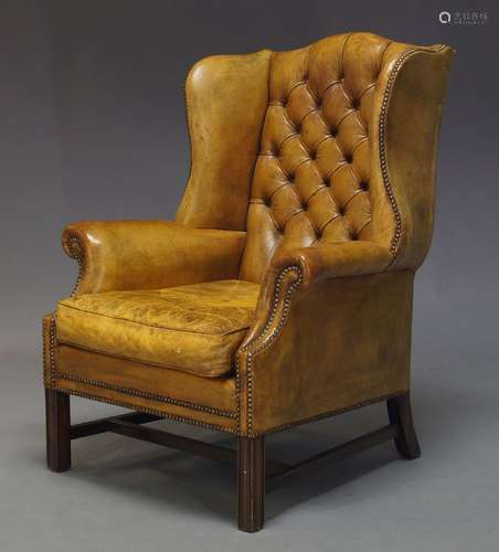 A George III style Wingback armchair, mid 20th Century, with green button back upholstery and