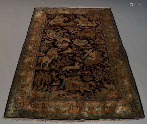 A Qum part silk rug, late 20th Century, with hunting scene on black ground, with ochre main