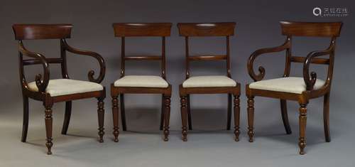 A set of four Regency mahogany bar back dining chairs, with cream upholstered drop in seats, on