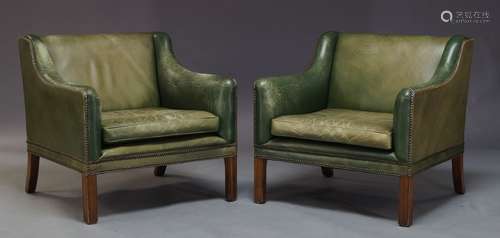 A pair of green leather armchairs, mid 20th Century, the square backs with down swept arms and brass