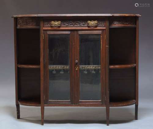 A Victorian side cabinet, the shaped top above foliate carved frieze with single drawer, over two