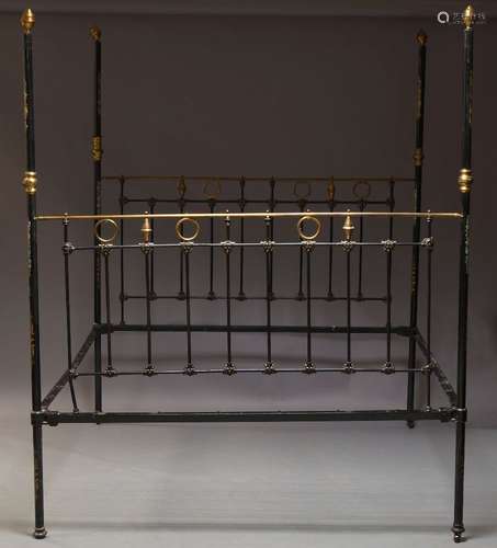 A Victorian black painted four poster double bed, with brass finials and fittings, the posts with