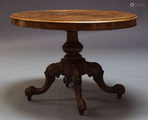 A Victorian walnut loo table, the oval quarter veneered top on carved baluster form support, to four