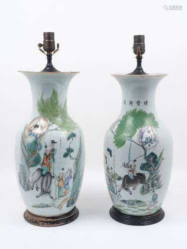 A pair of early 20th century Chinese vases, each of baluster form with wooden stepped bases,