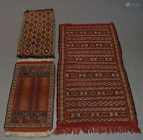 An Anatolian Kilim rug, with rows of geometric motifs, together with two kilim mats and two