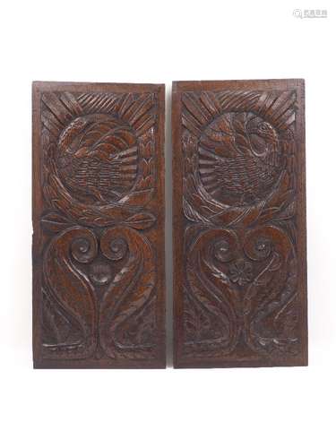 A pair of 17th century panels, each designed with stylised bird motifs, to a foliate surround, a top