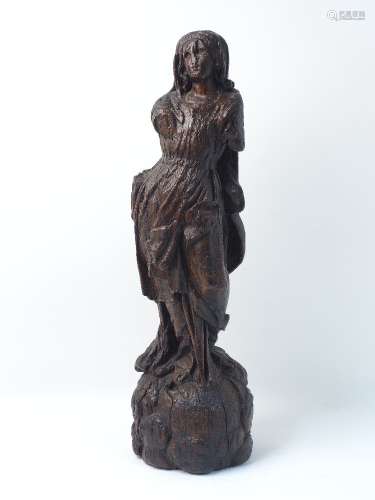 A North European wood carving, 16th century, designed as standing woman in drapery to a naturalistic
