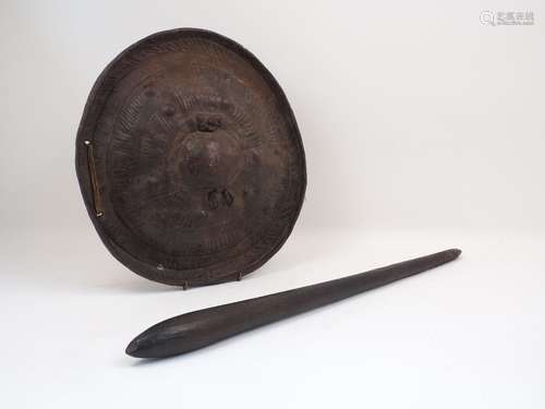 A 19th century African / Polynesian leather bound shield, 42cm diameter, together with a wooden