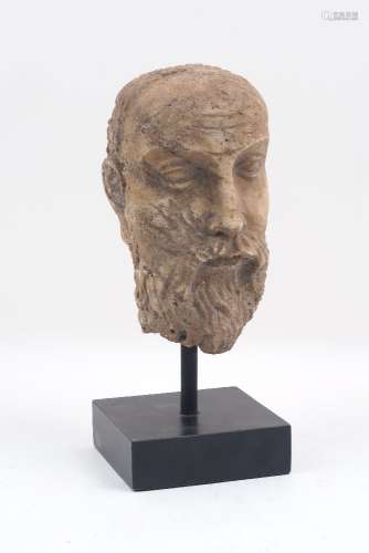 A carved stone bust, 17th century style, designed after a Greek Philosopher, to an ebonised stand,