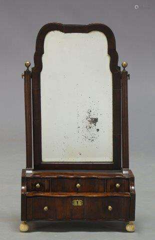 A George II mahogany toilet mirror, the shaped frame with beveled mirror plate, on moulded