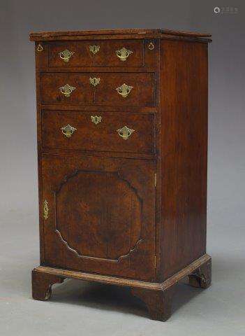 A George I walnut bachelor's cabinet, with feather banded fold over top, above three drawers and