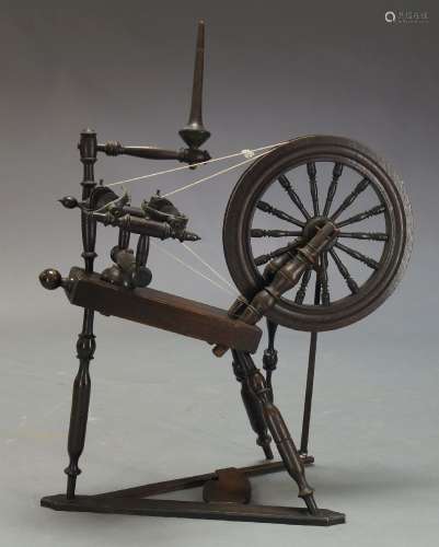 An oak spinning wheel, 19th Century, with turned tripod supports, 102cm high, approx. 87cm