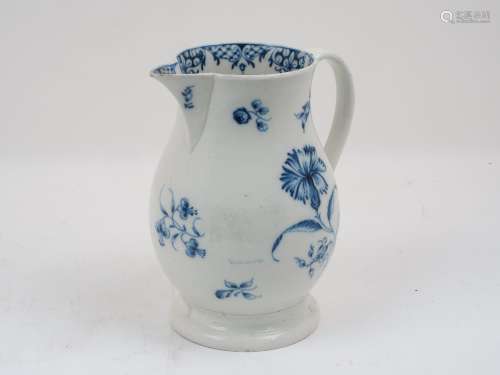 A Liverpool porcelain blue and white jug of baluster form, decorated with floral sprays to body