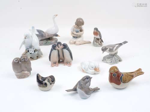 A group of eight small Royal Copenhagen porcelain figure groups depicting various birds, with one