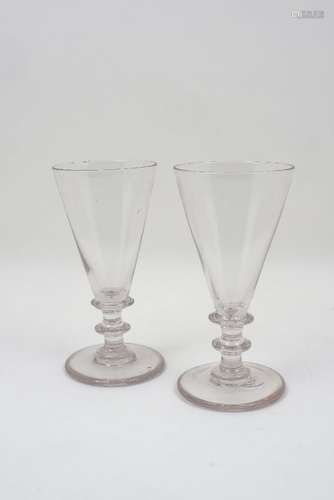 A pair of George III ale glasses, with conical bowls and knopped stems, each 19.5cm high (2)Please