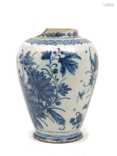 A tin glazed earthenware blue and white jar, probably 18th century, decorated with flowers, damages,