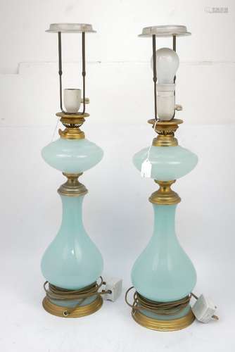 A pair of continental opaline glass table lamps, 20th century, the compressed reservoir above